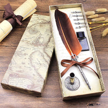 Feather quill pen set with ink bottle in a decorative box on a wooden surface