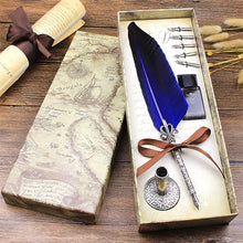Quill pen set with blue feather and ink bottle in a decorative box on a wooden surface.