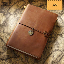 Brown leather notebook with a strap and decorative buckle on an old map background