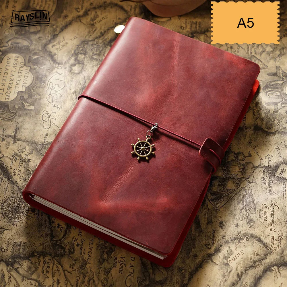 Red leather notebook with a charm on a vintage map background