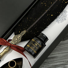 Feather pen set with ink bottle and decorative elements in a box