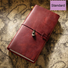 Red leather notebook with a metal clasp on an old map background
